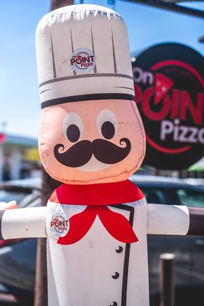 A close look at the inflatable chef with a red neckerchief and a big mustache