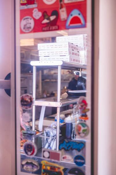 The shop's glass door covered in stickers