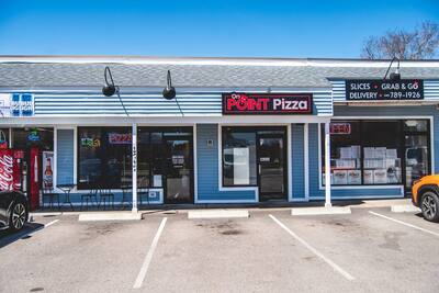 The On Point Pizza storefront in the plaza on Point Judith Road with parking out front